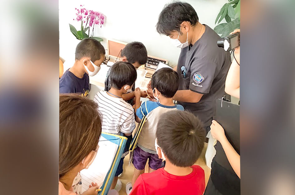 とちぎ うさぎ・ことり・ちびっこ動物の病院の院長の寺田さんと動物を一緒に見る子どもたち